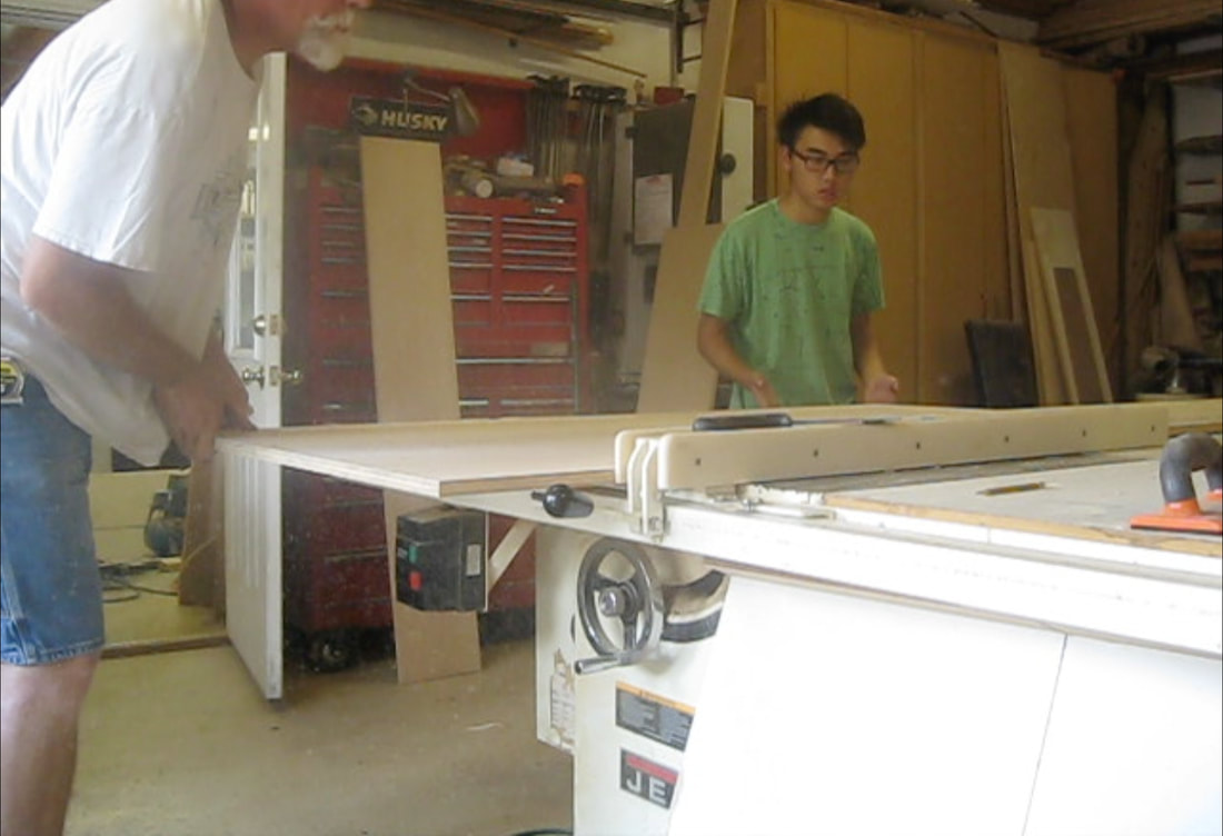 Me assisting my mentor in table sawing wood