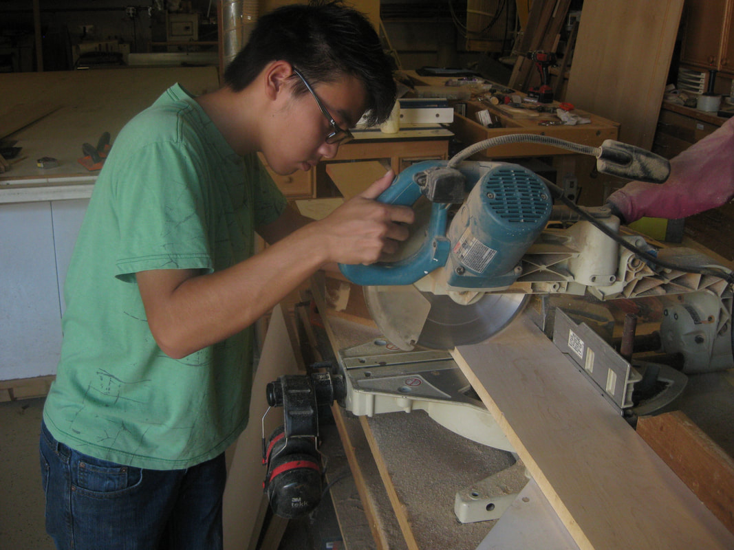 Me chop sawing wood boards for the faces of the drawer boxes